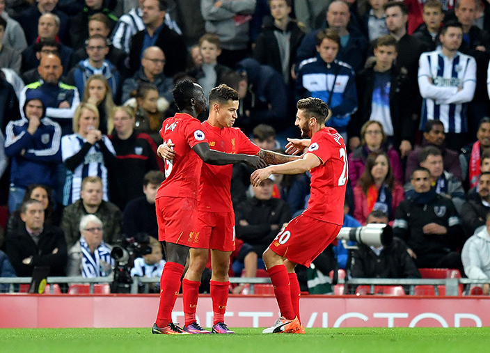 Liverpool's Philippe Coutinho, centre, celebrates scoring his side's second goal of the game during the English Premier League soccer match between Liverpool and West Bromwich Albion at Anfield stadium, Liverpool, England, Saturday, Oct. 22, 2016. (Dave Howarth/PA via AP)