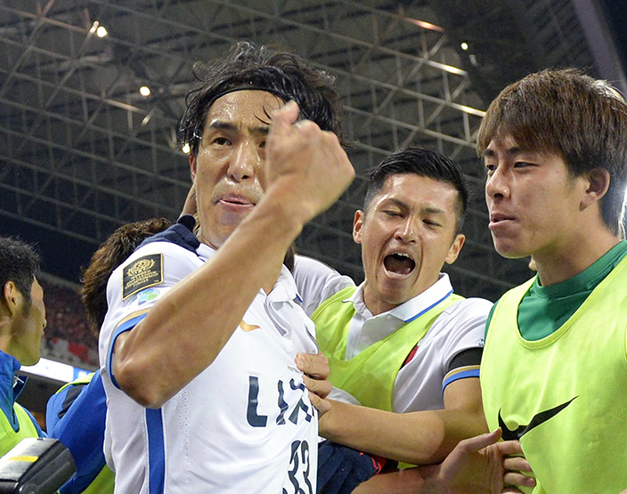 Kashima Antlers' Mu Kanazaki, left, celebrates with teammates after scoring a goal against Urawa Reds in the second half of their second leg soccer match of the J-League Championship Final at Saitama Stadium in Saitama, near Tokyo, Saturday, Dec. 3, 2016. Kashima beat Urawa 2-1 to claim their eighth title. (Takumi Sato/Kyodo News via AP)