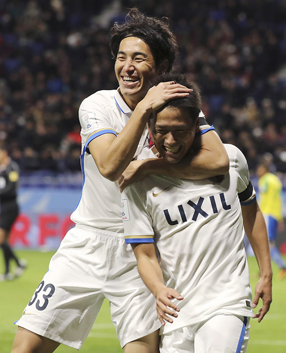 Kashima Antlers' Yasushi Endo, right, celebrates his goal with his teammate Mu Kanazaki, left, during their match against Mamelodi Sundowns at the FIFA Club World Cup soccer tournament at Suita City Football Stadium in Suita, west Japan, Sunday, Dec. 11, 2016. (AP Photo/Eugene Hoshiko)