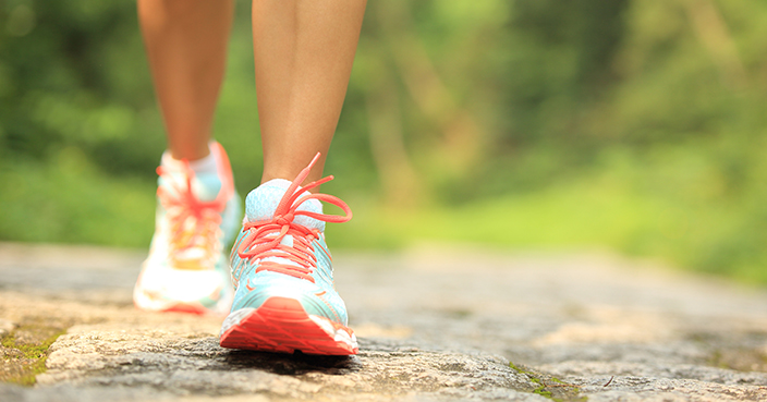 fitness woman hiker feet hiking on stone trail