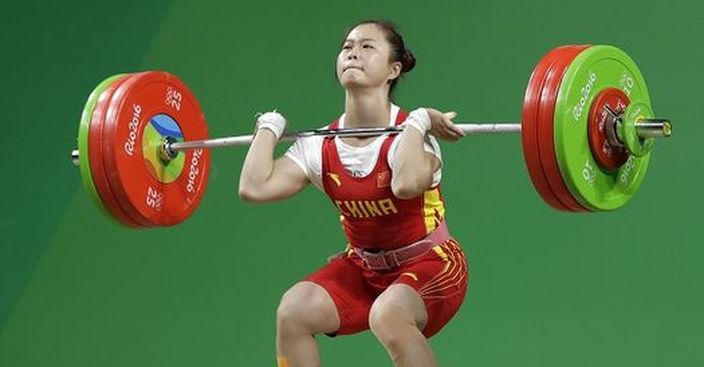 Deng Wei, of China, sets a weight class world record with a 147 kg lift in the clean and jerk during the women's 63kg weightlifting competition at the 2016 Summer Olympics in Rio de Janeiro, Brazil, Tuesday, Aug. 9, 2016. (AP Photo/Mike Groll)