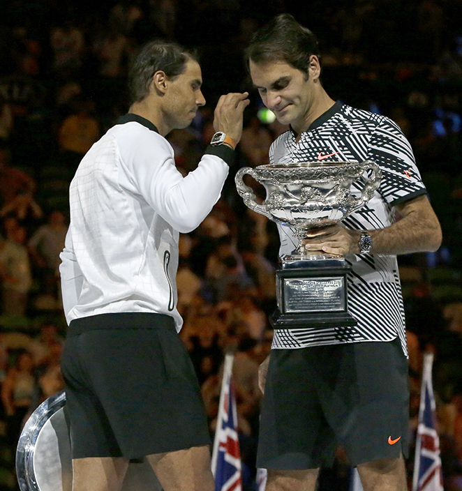 Switzerland's Roger Federer, right, holds his trophy after defeating Spain's Rafael Nadal, left, during their men's singles final at the Australian Open tennis championships in Melbourne, Australia, Sunday, Jan. 29, 2017. (AP Photo/Aaron Favila)