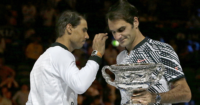 Switzerland's Roger Federer, right, holds his trophy after defeating Spain's Rafael Nadal, left, during their men's singles final at the Australian Open tennis championships in Melbourne, Australia, Sunday, Jan. 29, 2017. (AP Photo/Aaron Favila)