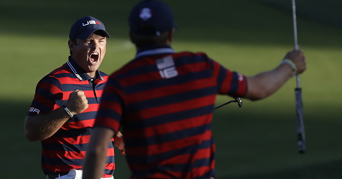 United States’ Patrick Reed reacts with teammate United States’ Jordan Spieth as he makes his put to win the match on the 15th hole during a four-ball match at the Ryder Cup golf tournament Saturday, Oct. 1, 2016, at Hazeltine National Golf Club in Chaska, Minn. (AP Photo/Chris Carlson)