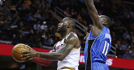 Cleveland Cavaliers' LeBron James, left, goes up for a shot past Orlando Magic's Bismack Biyombo during the first half of an NBA preseason basketball game Wednesday, Oct. 5, 2016, in Cleveland. (AP Photo/Ron Schwane)
