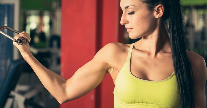 Beautiful fit woman working out in gym girl in fitness