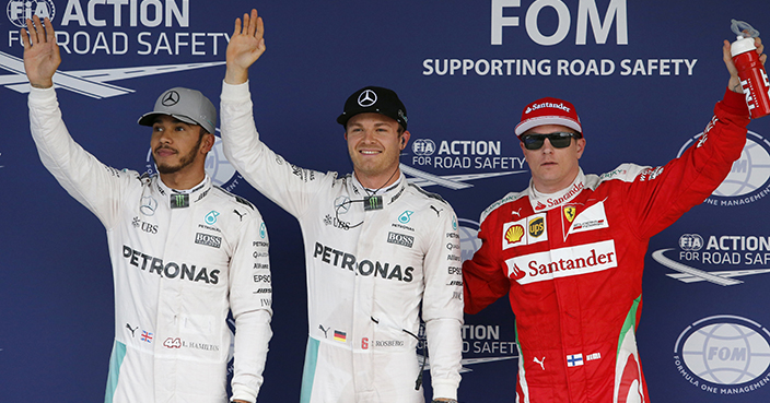 Mercedes driver Nico Rosberg, center, waves with teammate Lewis Hamilton, left, of Britain and Ferrari driver Kimi Raikkonen of Finland after taking pole for the Japanese Formula One Grand Prix at the Suzuka Circuit in Suzuka, central Japan, Saturday, Oct. 8, 2016. Hamilton finished second and Raikkonen was third. (AP Photo/Toru Takahashi)