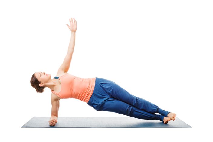 Woman doing yoga asana Vasisthasana - side plank pose