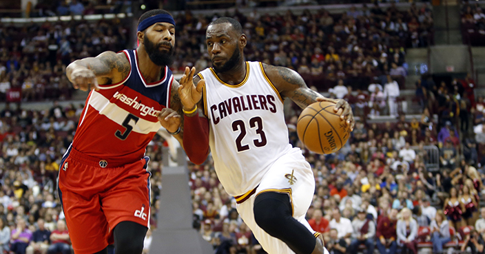 Cleveland Cavaliers' LeBron James, right, drives to the basket against Washington Wizards' Markieff Morris during the first half of an NBA preseason basketball game, Tuesday, Oct. 18, 2016, in Columbus, Ohio. The Wizards defeated the Cavaliers 96-91. (AP Photo/Jay LaPrete)