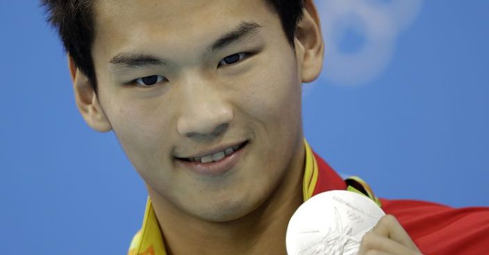 China's Xu Jiayu shows off his silver medal during the ceremony for the men's 100-meter backstroke final at the swimming competitions at the 2016 Summer Olympics, Monday, Aug. 8, 2016, in Rio de Janeiro, Brazil. (AP Photo/Michael Sohn)