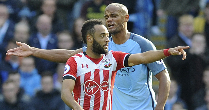 Southampton's Nathan Redmond, foreground, reacts after scoring as Manchester City's Vincent Kompany gestures, during the English Premier League soccer match between Manchester City and Southampton at the Etihad Stadium in Manchester, England, Sunday, Oct. 23, 2016. (AP Photo/Rui Vieira)