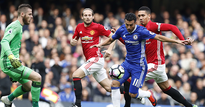 Chelsea’s Pedro flies past Manchester United’s goalkeeper David de Gea, left, Manchester United’s Chris Smalling, right, and Manchester United’s Daley Blind, rear, to score during the English Premier League soccer match between Chelsea and Manchester United at Stamford Bridge stadium in London, Sunday, Oct. 23, 2016.(AP Photo/Kirsty Wigglesworth)