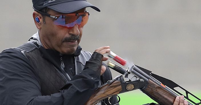 Fehaid Aldeehani, an independent athlete from Kuwait competing on the Refugee Olympic Team, ejects empty cartridges during the men's double trap gold medal match at Olympic Shooting Center at the 2016 Summer Olympics in Rio de Janeiro, Brazil, Wednesday, Aug. 10, 2016. (AP Photo/Eugene Hoshiko)