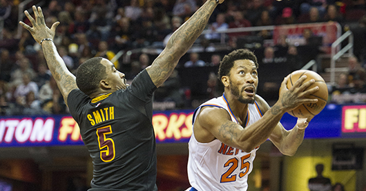 New York Knicks' Derrick Rose (25) drives past Cleveland Cavaliers' J.R. Smith (5) as the Cavaliers LeBron James watches during the first half of an NBA basketball game in Cleveland, Tuesday, Oct. 25, 2016. (AP Photo/Phil Long)