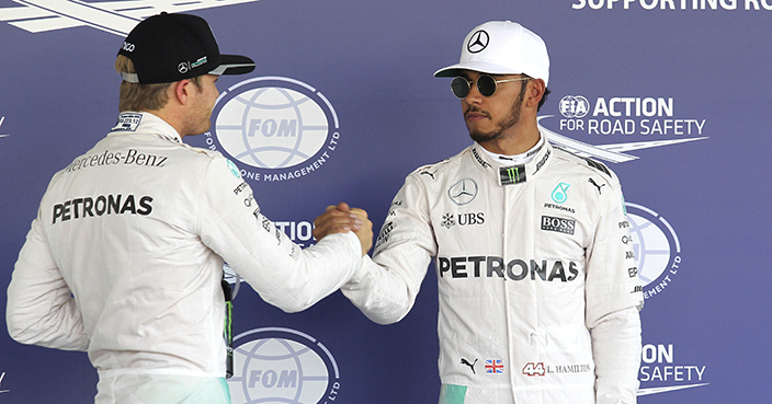 Mercedes driver Lewis Hamilton, of Britain, right, shakes hands with Mercedes teammate Nico Rosberg, of Germany, after qualification races for the Formula One Mexico Grand Prix auto race at the Hermanos Rodriguez racetrack in Mexico City, Saturday, Oct. 29, 2016. Hamilton grabbed the pole position and Rosberg fought back from his rough practice outings to earn the No. 2 spot. (Ulises Ruiz Basurto/Pool photo via AP)
