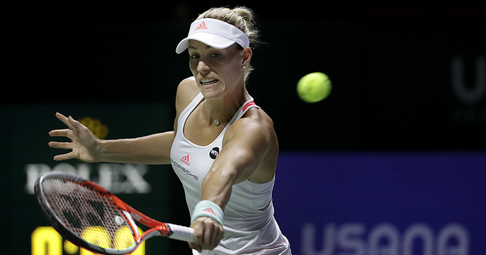 Angelique Kerber of Germany makes a backhand return against Agnieszka Radwanska of Poland during their singles match at the WTA tennis tournament in Singapore, Saturday, Oct. 29, 2016. (AP Photo/Wong Maye-E)