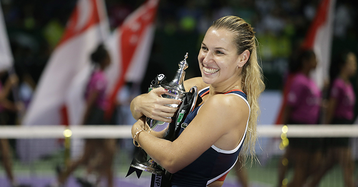 Dominika Cibulkova of Slovakia hugs her trophy after beating Angelique Kerber of Germany in their women's singles final match at the WTA tennis tournament in Singapore, Sunday, Oct. 30, 2016. (AP Photo/Wong Maye-E)