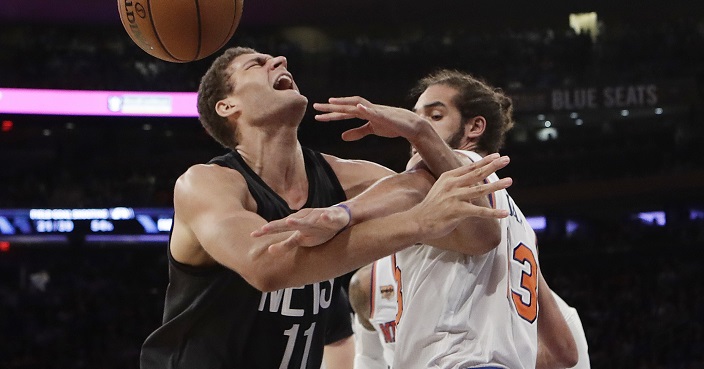 Brooklyn Nets' Brook Lopez (11) and New York Knicks' Joakim Noah (13) compete for control of the ball during the first half of an NBA basketball game Wednesday, Nov. 9, 2016, in New York. (AP Photo/Frank Franklin II)