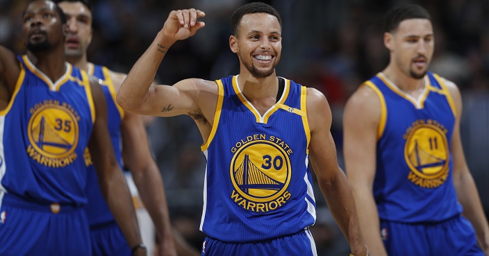 Golden State Warriors guard Stephen Curry, center, jokes with teammates Kevin Durant, left, and Klay Thompson after Curry hit a 3-point basket and was fouled by a Denver Nuggets player during the second half of an NBA basketball game Thursday, Nov. 10, 2016, in Denver. The Warriors won 125-101. (AP Photo/David Zalubowski)