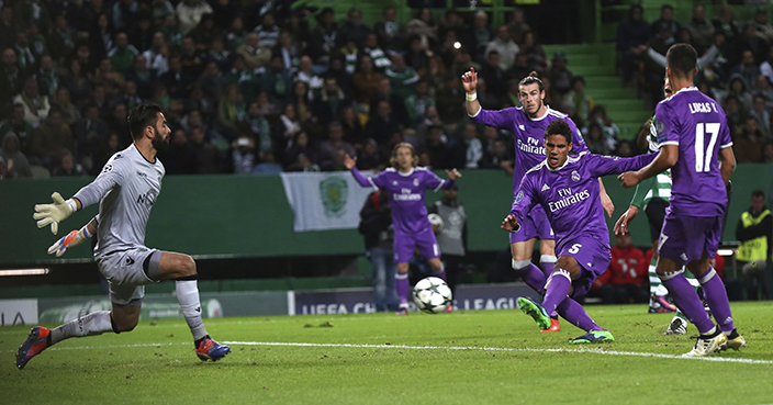 Real Madrid's Raphael Varane scores the opening goal during a Champions League, Group F soccer match between Sporting CP and Real Madrid at the Alvalade stadium in Lisbon, Tuesday, Nov. 22, 2016. (AP Photo/Steven Governo)