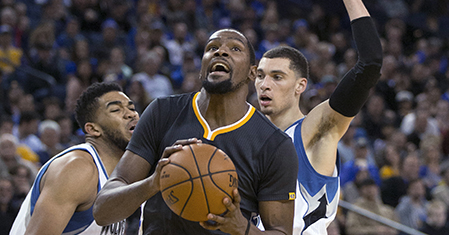 Golden State Warriors' Kevin Durant (35) drives to the basket between Minnesota Timberwolves' Karl-Anthony Towns (32) and Zach LaVine during the fourth quarter of an NBA basketball game, Saturday, Nov. 26, 2016, in Oakland, Calif. The Warriors won 115-102. (AP Photo/D. Ross Cameron)