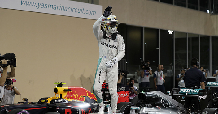 Mercedes driver Lewis Hamilton of Britain celebrates after qualifying for pole position during the qualifying session at the Yas Marina racetrack in Abu Dhabi, United Arab Emirates, Saturday, Nov. 26, 2016. The Emirates Formula One Grand Prix will take place on Sunday. (AP Photo/Hassan Ammar)