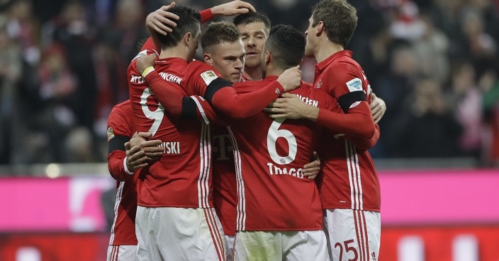 Bayern's Thiago, foreground centre, celebrates with teammates after scoring his side's first goal during the German Bundesliga soccer match between FC Bayern Munich and Bayer Leverkusen 04 at the Allianz Arena stadium in Munich, Germany, Saturday, Nov. 26, 2016. (AP Photo/Matthias Schrader)