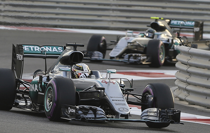 Mercedes driver Lewis Hamilton of Britain, left, steers his car around a corner ahead of team mate Mercedes driver Nico Rosberg of Germany during the Emirates Formula One Grand Prix at the Yas Marina racetrack in Abu Dhabi, United Arab Emirates, Sunday, Nov. 27, 2016. (AP Photo/Kamran Jebreili)