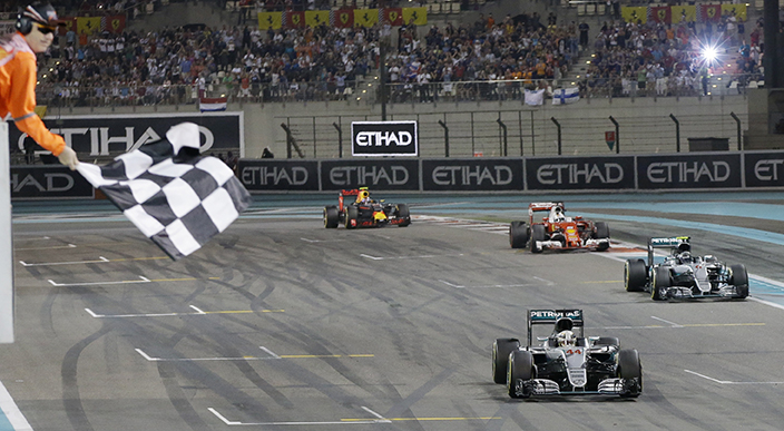 Mercedes driver Lewis Hamilton of Britain is about to cross the finish line to win the Emirates Formula One Grand Prix, followed by his teammate Mercedes driver Nico Rosberg of Germany, Ferrari driver Sebastian Vettel of Germany and Red Bull driver Max Verstappen of the Netherlands at the Yas Marina racetrack in Abu Dhabi, United Arab Emirates, Sunday, Nov. 27, 2016. (AP Photo/Luca Bruno)