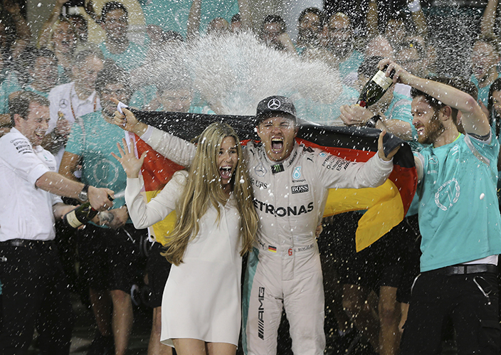 Mercedes driver Nico Rosberg of Germany, center right, is sprayed with champagne by his team after placing second and becoming 2016 world champion at the Emirates Formula One Grand Prix at the Yas Marina racetrack in Abu Dhabi, United Arab Emirates, Sunday, Nov. 27, 2016. (AP Photo/Kamran Jebreili)