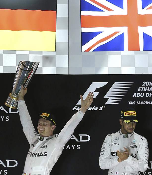 Mercedes driver Lewis Hamilton of Britain, right and Mercedes driver Nico Rosberg of Germany celebrate during the podium ceremony after the Emirates Formula One Grand Prix at the Yas Marina racetrack in Abu Dhabi, United Arab Emirates, Sunday, Nov. 27, 2016. Hamilton took first place in the race with Rosberg finishing second and becoming 2016 world champion. (AP Photo/Kamran Jebreili)