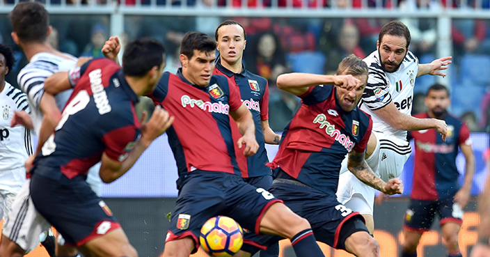 Juventus' Gonzalo Higuain, right,  kicks the ball as in action with Genoa's Luca Rigoni, second from right, and Genoa's Ezequiel Munoz, second from left,  during the Serie A soccer match between Genoa and Juventus at the Luigi Ferraris stadium in Genoa, Italy, Sunday, Nov. 27, 2016. ( Simone Arveda /ANSA via AP)