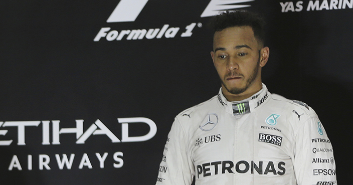 Mercedes driver Nico Rosberg of Germany, left, celebrates as his teammate Mercedes driver Lewis Hamilton of Britain looks on, on the podium after the Emirates Formula One Grand Prix at the Yas Marina racetrack in Abu Dhabi, United Arab Emirates, Sunday, Nov. 27, 2016. (AP Photo/Kamran Jebreili)