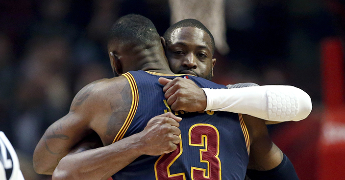 Chicago Bulls guard Dwyane Wade, rear, hugs Cleveland Cavaliers forward LeBron James before an NBA basketball game Friday, Dec. 2, 2016, in Chicago. (AP Photo/Nam Y. Huh)
