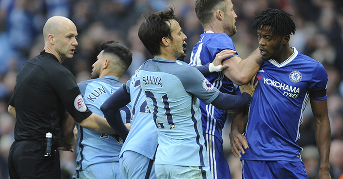 Manchester City's Sergio Aguero, 2nd left, is sent off by referee Anthony Taylor, left, for a tackle on Chelsea's David Luiz, on floor, during the English Premier League soccer match between Manchester City and Chelsea at the Etihad Stadium in Manchester, England, Saturday, Dec. 3, 2016. (AP Photo/Rui Vieira)