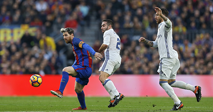 Barcelona's Lionel Messi, left, vies for the ball with Daniel Carvajal, centre, and Sergio Ramos during of the Spanish La Liga soccer match between FC Barcelona and Real Madrid at the Camp Nou in Barcelona, Spain, Saturday, Dec. 3, 2016. The match ended in a 1-1 draw. (AP Photo/Francisco Seco)