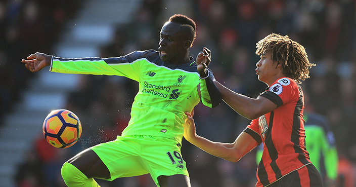 Liverpool's Sadio Mane, left, and AFC Bournemouth's Nathan Ake battle for the ball during the English Premier League soccer match at the Vitality Stadium, Bournemouth, England, Sunday Dec. 4, 2016. (Adam Davy/PA via AP)