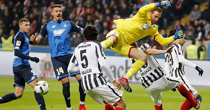 Hoffenheim goalkeeper Oliver Baumann is in the air during a German first division Bundesliga match between Eintracht Frankfurt and TSG 1899 Hoffenheim in Frankfurt, Germany, Friday, Dec. 9, 2016. (AP Photo/Michael Probst)