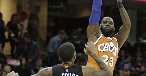 Cleveland Cavaliers' LeBron James (23) shoots over Miami Heat's Rodney McGruder (17) in the first half of an NBA basketball game Friday, Dec. 9, 2016, in Cleveland. (AP Photo/Tony Dejak)