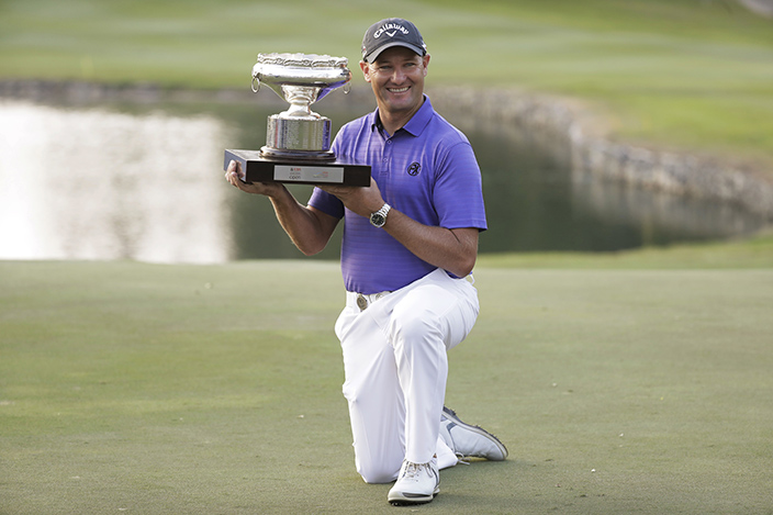 Australia's Sam Brazel poses with the trophy after winning the Hong Kong Open golf tournament in Hong Kong, Sunday, Dec. 11, 2016. Brazel birdied the 18th hole to narrowly edge Rafa Cabrera Bello of Spain to capture the Hong Kong Open on Sunday, his first title on the European Tour. (AP Photo/Kin Cheung)