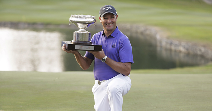 Australia's Sam Brazel poses with the trophy after winning the Hong Kong Open golf tournament in Hong Kong, Sunday, Dec. 11, 2016. Brazel birdied the 18th hole to narrowly edge Rafa Cabrera Bello of Spain to capture the Hong Kong Open on Sunday, his first title on the European Tour. (AP Photo/Kin Cheung)