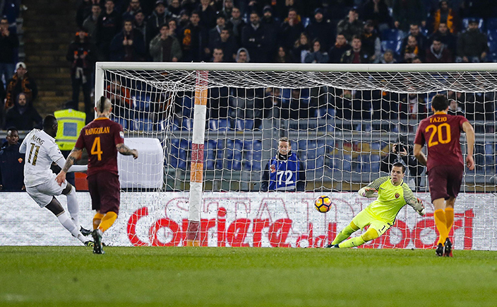 Roma goalkeeper Wojciech Szczesny saves a penalty kicked by AC Milan's MBaye Niang, left, during a Serie A soccer match between AC Milan and Rome, at Rome's Olympic stadium, Monday, Dec. 12, 2016. (Angelo Carconi/ANSA via AP)