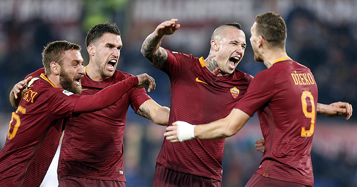 Roma's Radja Nainggolan, second from right, celebrates after scoring during a Serie A soccer match against AC Milan at Rome's Olympic stadium, Monday, Dec. 12, 2016. (Angelo Carconi/ANSA via AP)