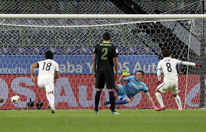 Kashima Antlers' Shoma Doi, right, scores a penalty goal during their match against Atletico Nacional's at the FIFA Club World Cup soccer tournament at Suita City Football Stadium in Suita, western Japan, Wednesday, Dec. 14, 2016. (AP Photo/Eugene Hoshiko)