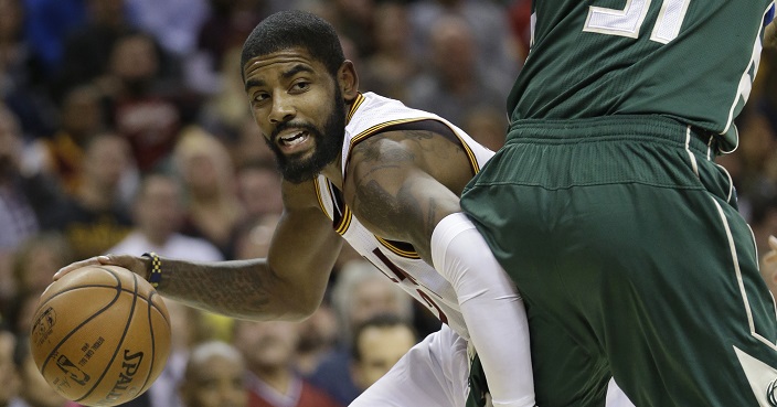 Cleveland Cavaliers' Kyrie Irving (2) drives past Milwaukee Bucks' John Henson (31) during the first half of an NBA basketball game, Wednesday, Dec. 21, 2016, in Cleveland. The Cavaliers won 113-102. (AP Photo/Tony Dejak)