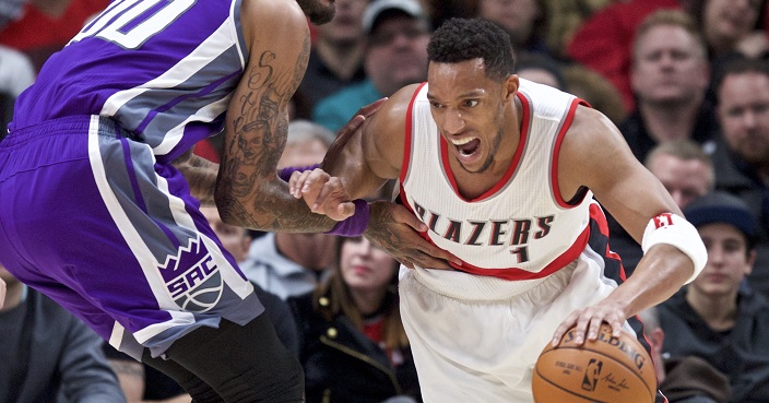 Portland Trail Blazers guard Evan Turner, right, dribbles past Sacramento Kings center Willie Cauley-Stein during the first half of an NBA basketball game in Portland, Ore., Wednesday, Dec. 28, 2016. (AP Photo/Craig Mitchelldyer)