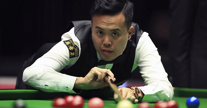 Marco Fu at the table during his match against Mark Allen on day five of the Masters snooker tournament at Alexandra Palace in London, Thursday Jan. 19, 2017.  (John Walton/PA via AP)