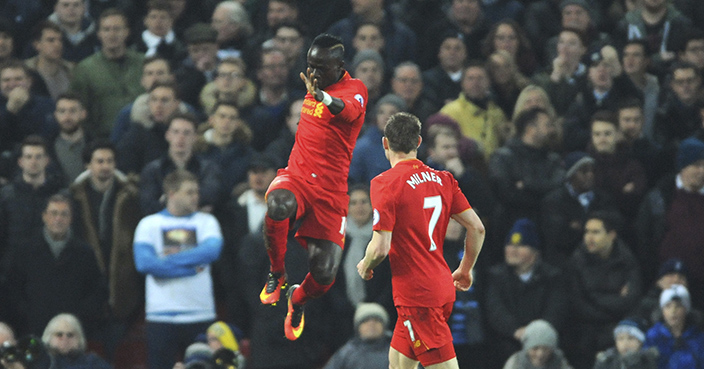 Liverpool's Sadio Mane, left, celebrates scoring his side's first goal during the English Premier League soccer match between Liverpool and Tottenham Hotspur at Anfield, Liverpool, England, Saturday, Feb. 11, 2017. (AP Photo/Rui Vieira)