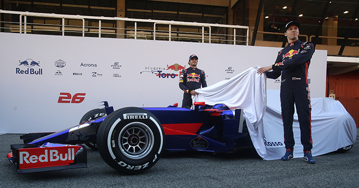 Scuderia Toro Rosso's Russian driver Daniil Kvyat, right, and Spanish driver Carlos Sainz unveil the new STR12 car during their official presentation at the Catalunya racetrack in Montmelo just outside of Barcelona, Spain, Sunday, Feb. 26, 2017. (AP Photo/Manu Fernandez)