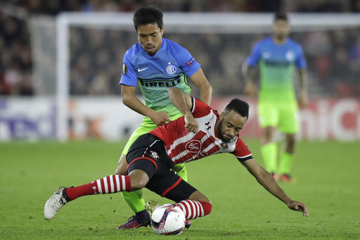 Inter Milan's Yuto Nagatomo, rear, and Southampton's Nathan Redmond vie for the ball during the Europa League group K stage soccer match between Southampton and Internazionale at St. Mary's Stadium in Southampton, England, Thursday, Nov. 3, 2016. (AP Photo/Matt Dunham)